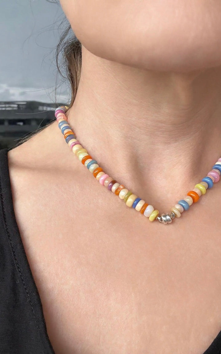 Multicolor Ethiopian opal necklace with magnetic clasp worn by a person with a blurred background