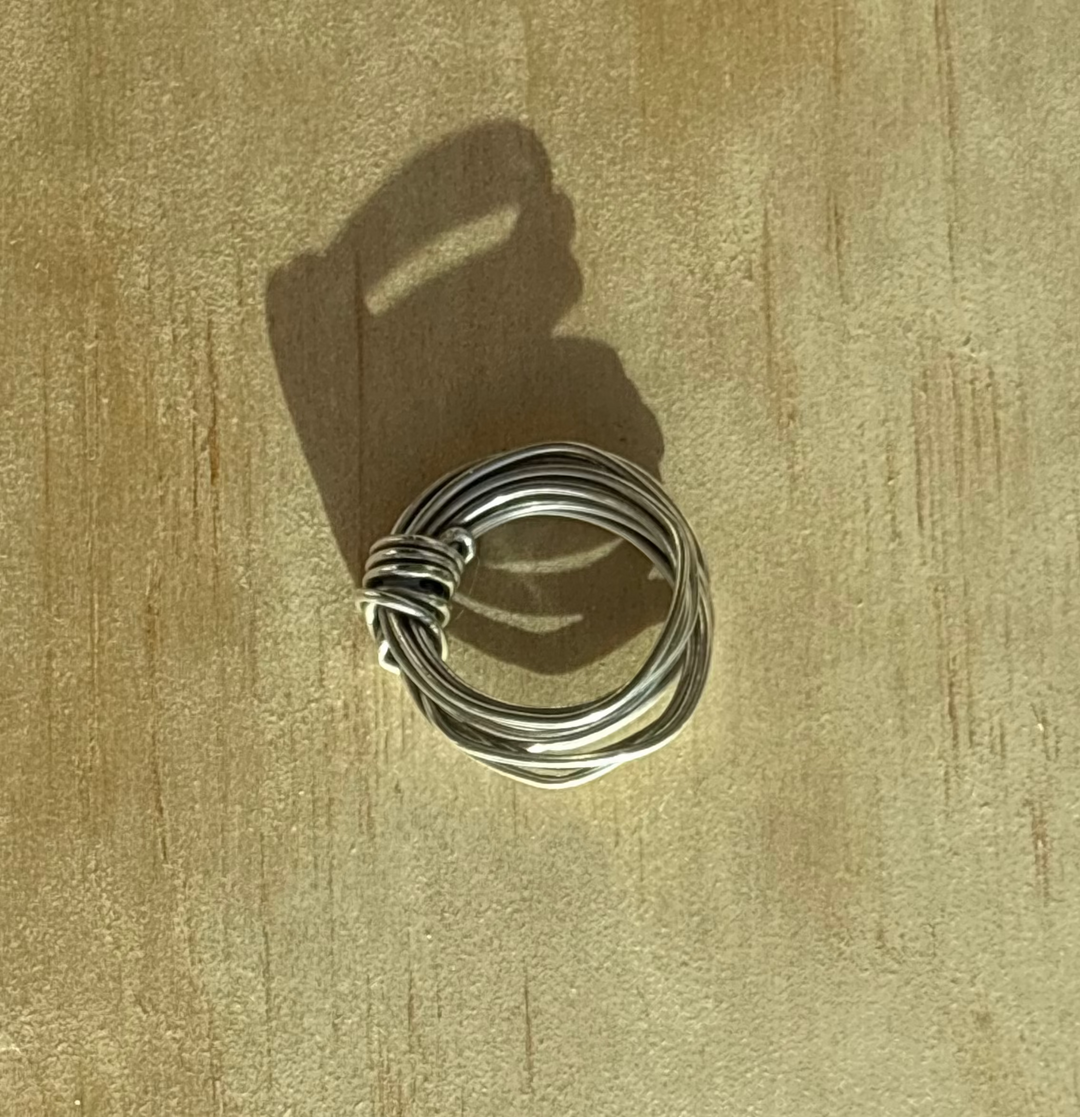 Handcrafted Amanda Ring by Jewelry One of a KIND, formed from a single 18-gauge wire into a sculptural knot without solder, available in brass and Fairmined sterling silver.