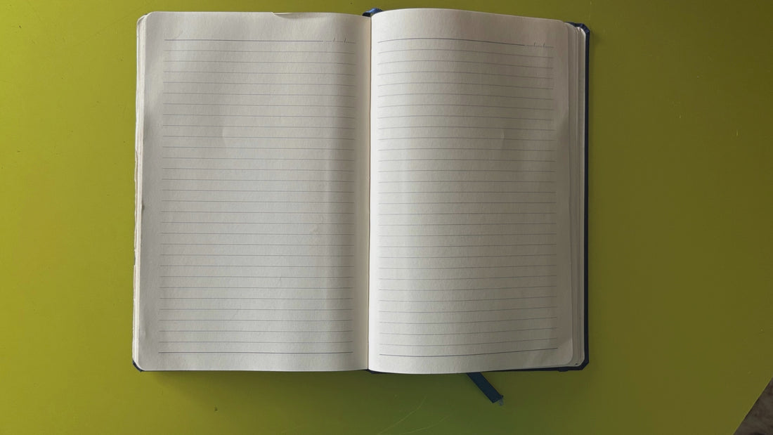 Brand story video showing a journal on a green background as the narrative writes itself across the page: founded in Miami by Amanda Nicol — designer, survivor, maker — building Jewelry One of a KIND to fund freedom through handcrafted pieces.