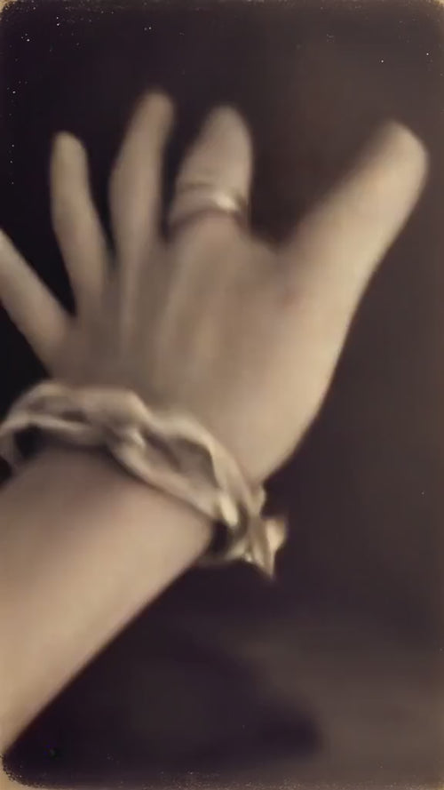Close-up motion video of  a hand  wearing the sculptural chunky large chain link Culebra Bracelet by Jewelry One of a KIND