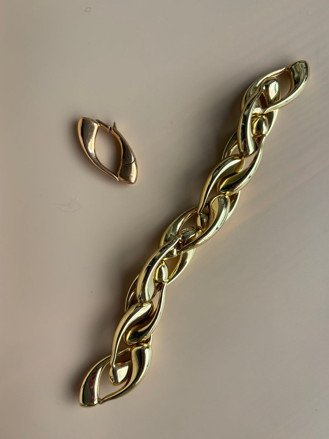 Close-up of the Signature Culebra Closure in cast bronze shown with the Limited Edition hollow brass Culebra Link Bracelet featuring a 2.5-micron gold-plated finish.