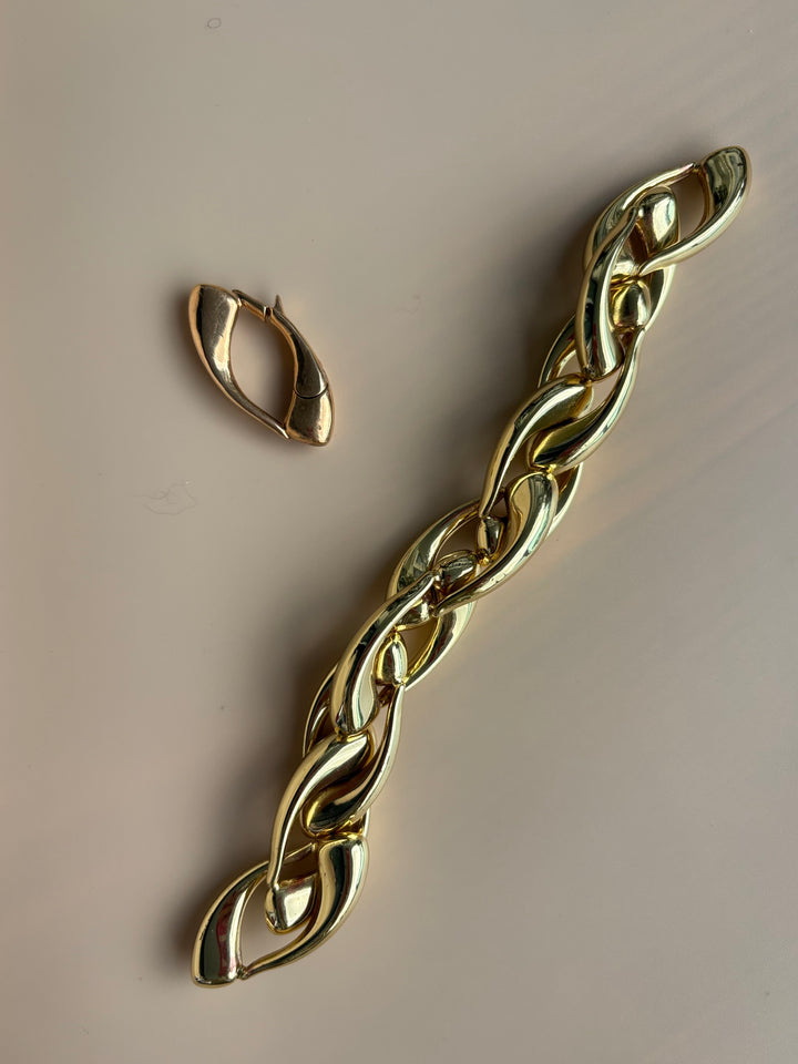 Close-up of the Signature Culebra Closure in cast bronze shown with the Limited Edition hollow brass Culebra Link Bracelet featuring a 2.5-micron gold-plated finish.